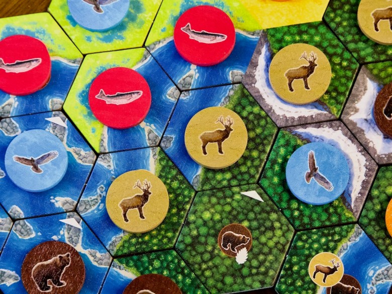 Tiles and wooden wildlife tokens in Cascadia Board Game by AEG and Flatout 