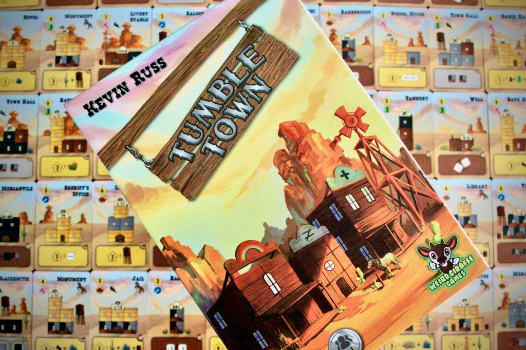 The box cover and building cards featured in Tumble Town board game by Weird Giraffe Games