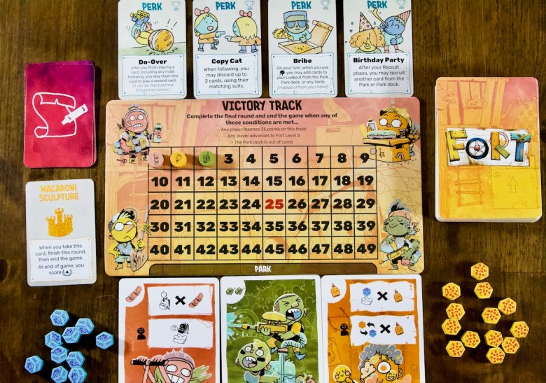 Scoring Victory Point VP Track for Fort by Leder Games including kids in the park who are ready to play, pizza, toys, perks, made up rules, and the macaroni sculpture