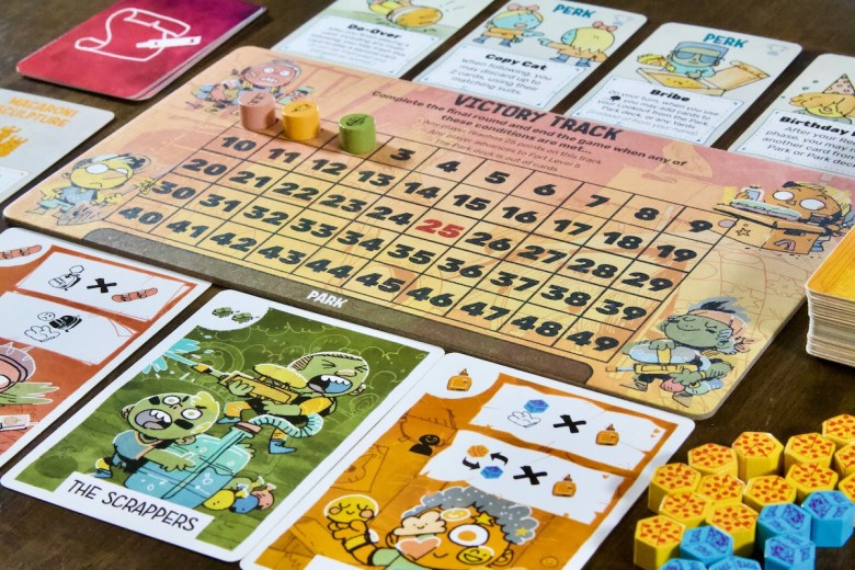 Victory point VP Track featuring resources pizza and toys, perks, make up rules, and kid cards in the yard