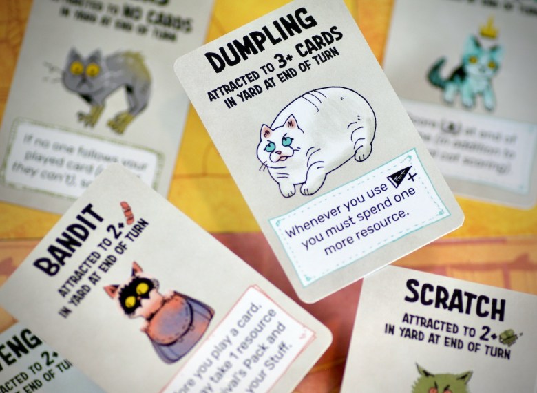 Dumpling, Bandit and Scratch are all cats that can play in your yard in Fort: Cats & Dogs Expansion by Leder Games
