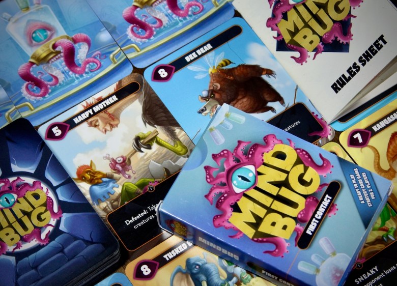 Mindbug: First Contact Card Game with all the components, rules sheet, cards, and tuck box